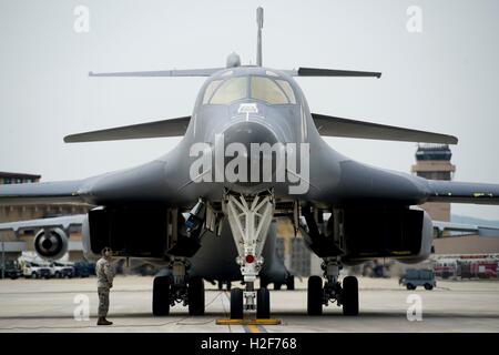 U.S. Air Force soldiers work on a B-1B Lancer stealth bomber aircraft after its landing at the Osan Air Force Base September 21, 2016 in Osan, South Korea. Stock Photo