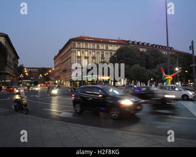 milan by night with traffic, Cadorna Station, 'Ago e filo' sculpture by the famous artist Claes Oldenburg Stock Photo