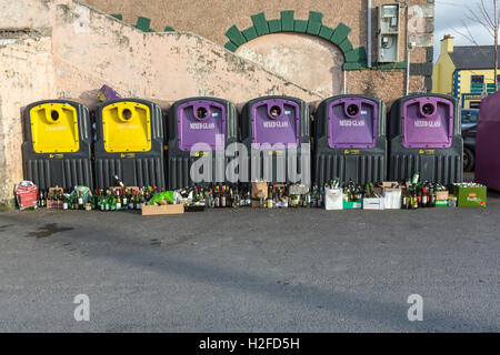 Glass bin recycling contained full of bottles Dunfanaghy, County Donegal, Ireland Stock Photo