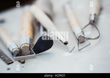 A row of hand tools for potters on  a workbench. Wire shaping tools. Stock Photo