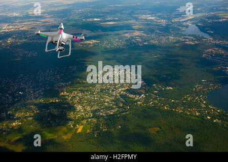 Quadrocopter flying over farmland Stock Photo