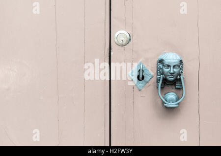Head of the Sphinx with iron knocker on old wooden door. Lock and key. Alchemy, mystery.  Other color Stock Photo