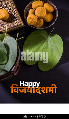 greeting card saying happy vijayadashmi or happy dussehra, indian festival dussehra, showing apta leaf or Bauhinia racemosa Stock Photo