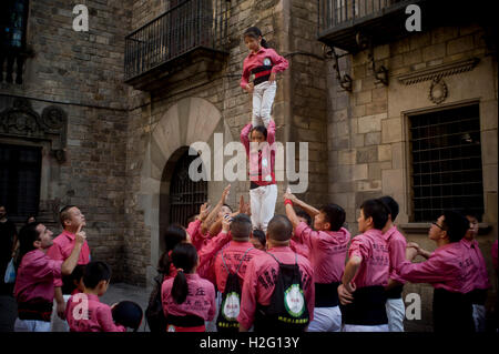 Members of the chinese Colla Xiquets de Hangzhou build a small human tower in Barcelona, Spain. Stock Photo
