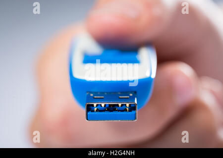 A child sharing digital computer files on a USB Stick Stock Photo