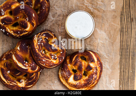 Refreshing beer ready to drink and fresh bavarian pretzels view from top. Traditional food and drink for german Oktoberfest Stock Photo