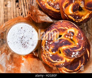 Refreshing beer ready to drink and fresh bavarian pretzels view from top. Traditional food and drink for german Oktoberfest Stock Photo