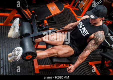 male bodybuilder doing leg curl in the gym Stock Photo