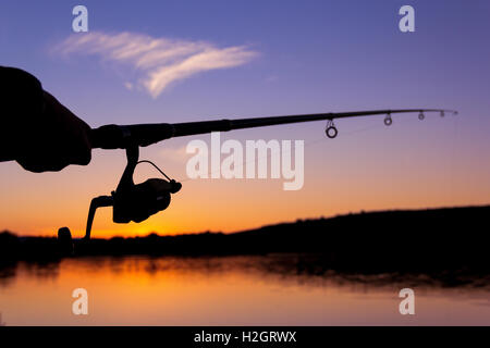 Closeup of woman fishing with fishing rod in sea Stock Photo - Alamy