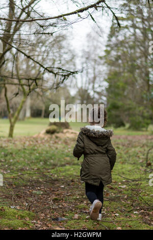 Small girl running in the park, Balloch Scotland UK Stock Photo