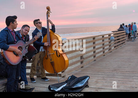 Pismo Beach, California. Musicians on the pier at sunset Stock Photo