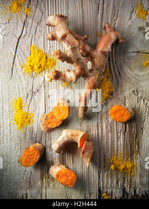 Fresh whole and cut turmeric or tumeric root (Curcuma longa) Stock Photo