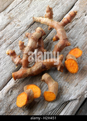 Fresh whole and cut turmeric or tumeric root (Curcuma longa) Stock Photo