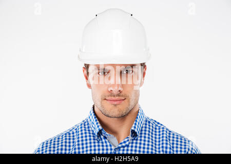 Portrait of serious young man architect in building helmet Stock Photo