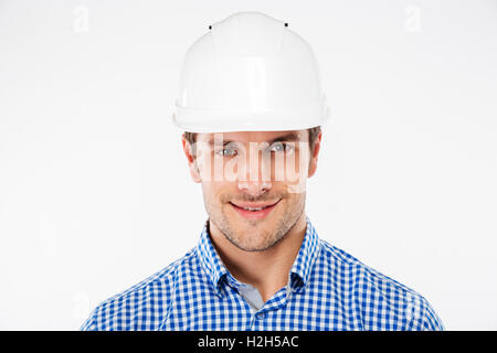 Closeup of smiling young man builder in hard hat Stock Photo