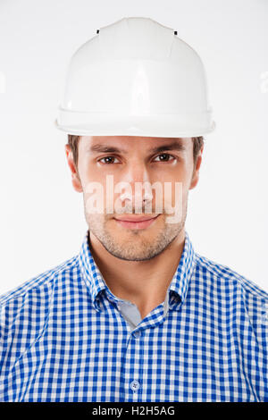 Closeup of serious young man building engineer in helmet Stock Photo