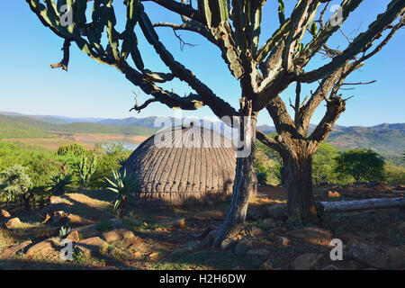 A traditional Zulu round beehive hut overlooking the Phobane Lake in  the   Shakaland Cultural Village near Durban South Africa Stock Photo