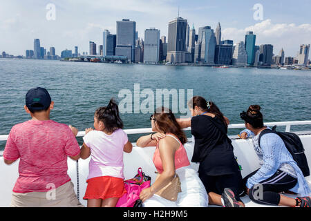 New York City,NY NYC,Brooklyn,New York Harbor,Brooklyn Bridge Park Pier 6,Governors Island Ferry,boat,passenger passengers rider riders,Manhattan skyl Stock Photo