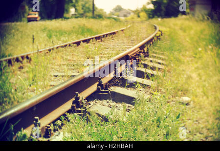 Train railroad disappearing in the distance. Soft focus. Retro style photo. Stock Photo