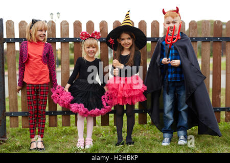 Cute friendly children in Halloween costumes Stock Photo