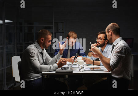 Group of creative designers working late in office Stock Photo