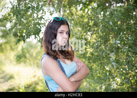 Teen girl standing near tree Stock Photo