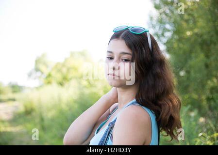 Girl teenager turned looking over shoulder Stock Photo