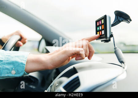 close up of man with icons on gadget driving car Stock Photo