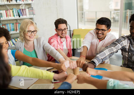 group of international students making fist bump Stock Photo