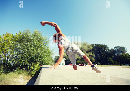 Young man in sportswear jumping in funny meme pose isolated on
