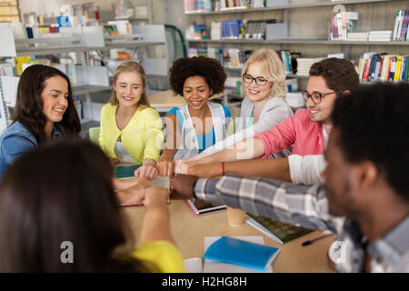 group of international students making fist bump Stock Photo