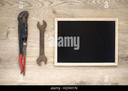 Rusty old hand tools with empty blackboard Stock Photo