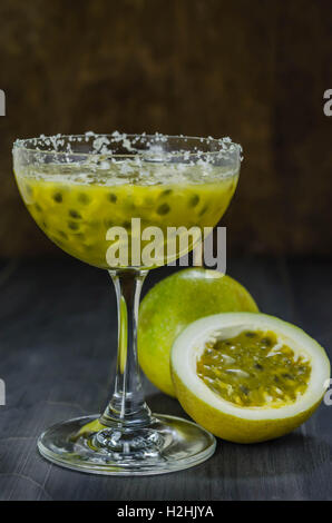 Fresh passion fruit juice in glass with passion fruits over wooden background , still life Stock Photo