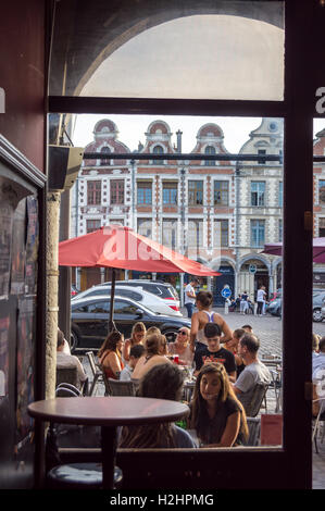 Drinkers seen through the window of Couleur Café bar, Place des Héros, Arras, Pas-de-Calais, Hauts de France, France Stock Photo