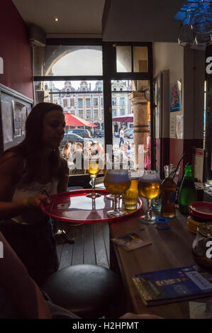 Drinkers in Place des Héros seen through the window of Couleur Café bar, Place des Héros, Arras, Pas-de-Calais,  Hauts de France, France Stock Photo