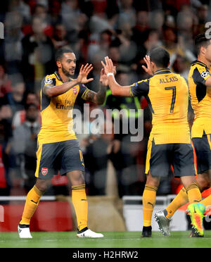 Arsenal's Theo Walcott celebrates scoring his side's second goal of the game with teammate Alexis Sanchez (right) during the UEFA Champions League, Group A match at the Emirates Stadium, London. Stock Photo