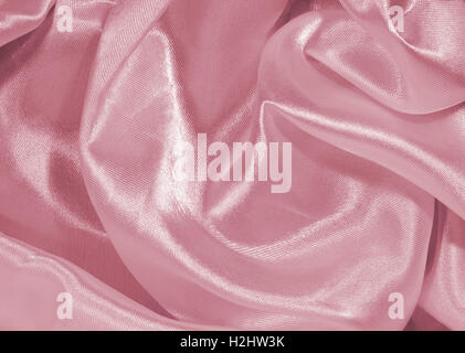 Abstract background representing synthetic / silk textile texture / pattern in pink. Stock Photo