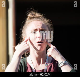 Female signer using sign language for people with impaired hearing at UK festival. Stock Photo