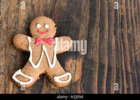 Christmas Gingerbread Man Cookie on Rustic wooden Background. Stock Photo