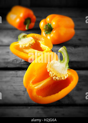 Fresh orange  bell peppers whole and cut Stock Photo