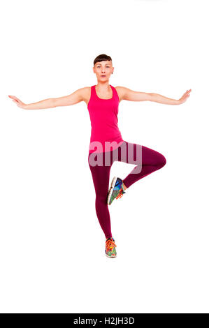 Young fitness woman balance, isolated over white background. Stock Photo