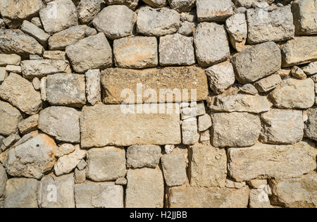 Traditional wall of stones built without lime. Dry stone wall. Stock Photo