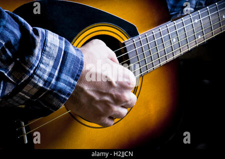 male guitarist playing an acoustic guitar Stock Photo