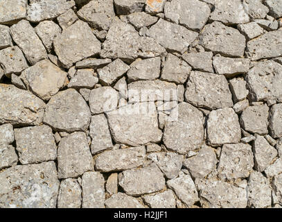 Traditional wall of stones built without lime. Dry stone wall. Stock Photo