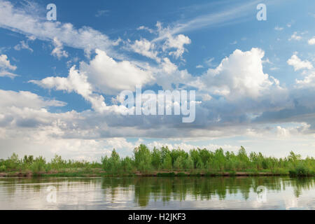 Landscape with river and cloudy sky. Sunny summer scene Stock Photo - Alamy