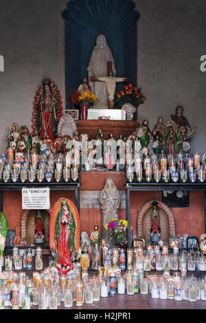 Candles and figurines in a Catholic church in Tuscon, Arizona Stock Photo