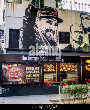 Portrait of Fidel Castro painted on a wall over a burger bar in Kuala Lumpur, Malaysia. Stock Photo