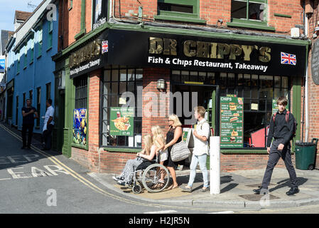 Dr Chippys Fish and Chip shop in Colchester Essex England with people walking past. The restaurant serves the traditional Britis Stock Photo