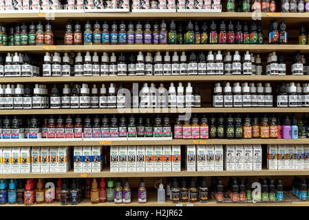 Rows of bottles of liquids of different flavors for vaping and vapors on display in a shop Stock Photo