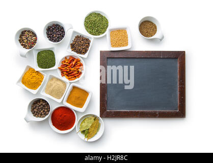 Blank chalkboard and various spices isolated on white background. Top view. Stock Photo